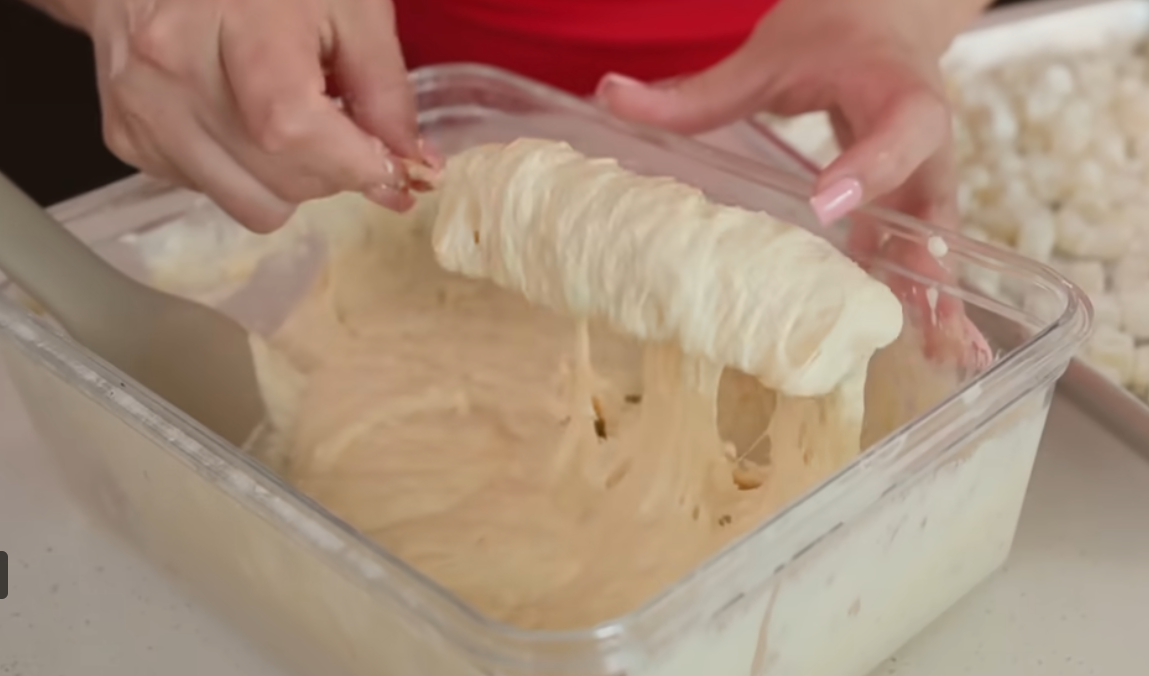Rolling Korean corn dog in panko breadcrumbs for outer coating